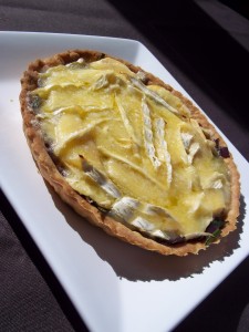 Spinach, apple and brie tart at a jaunty angle